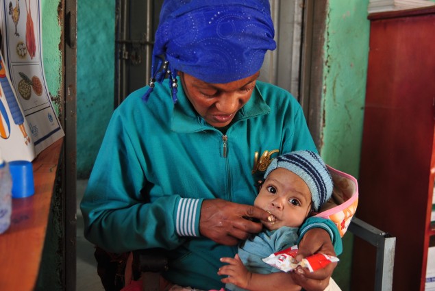 Natsaannat, a health extension worker in Wara Village, Ethiopia, counsels Aynamam on how to treat malnutrition in her child, Bitu.