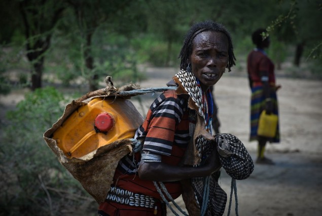 Image of woman carrying water container in Ethiopia