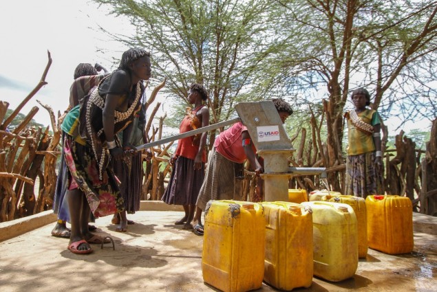 Image of woman pumping water from a well in Ethiopia