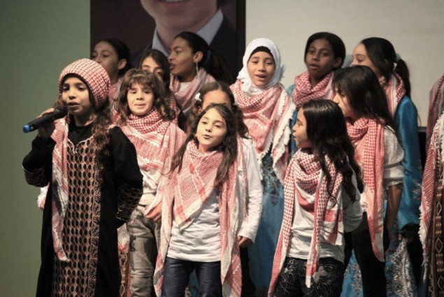 Female students perform a Jordanian national song in traditional attire at the opening of Khalwla Bint Al Azwar School in Mashar