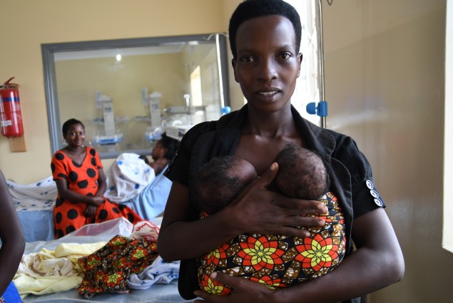 A woman in Malawi holds twin babies