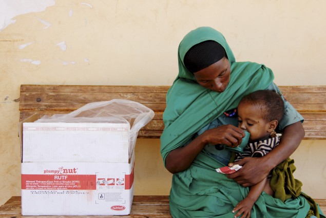 Two-year-old Seid eats high nutrient peanut paste provided by a health extension worker.  Yesriba, 28, with her son Seid, who is recovering from severe-acute malnutrition, in Sewena, Bale Zone. Weak from poor nutrition, the child was diagnosed and treated for pneumonia.