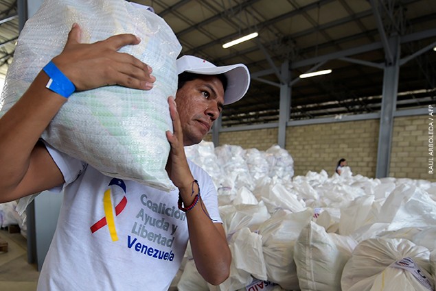 A volunteer carries a bag with US humanitarian aid goods in Cucuta, Colombia, on the border with Tachira, Venezuela.