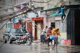  Residents are seen protecting themselves by the rain in the aftermath of the passage of the cyclone Idai in Beira, Mozambique, on March 17, 2019.