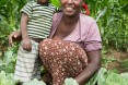 USAID beneficiary Aster Kasem and her son in their garden.