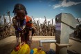 Image of woman in Ethiopia pumping water in village of Buluko