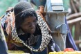 Image of woman in Ethiopia filling water jugs