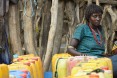Image of woman waiting to fill her water containers in Ethiopia