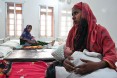 A mother holds her newborn at the Special Care Newborn Unit in Jaintapur Upazila in northern Bangladesh