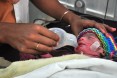 A health worker helps a newborn.