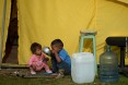 Venezuelan migrant children are seen outside a tent in a humanitarian camp in Bogota on January 9, 2019. 