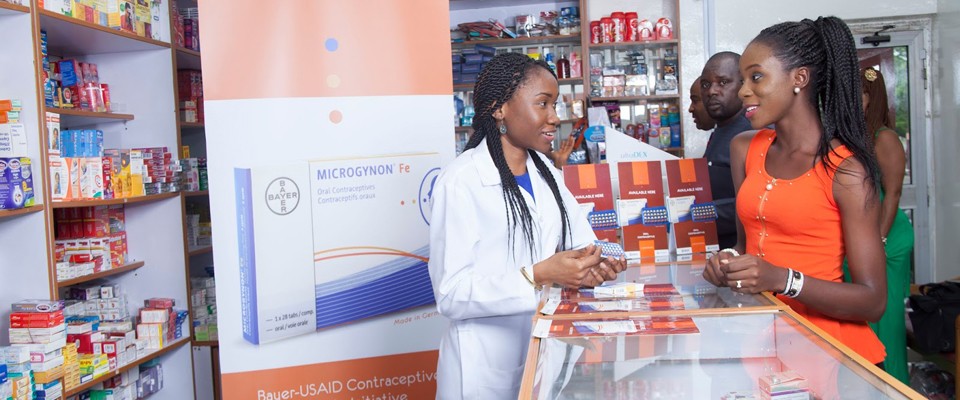 A pharmacist speaks to customers