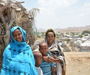 Khadija stands with her children outside of their home in Ali Addeh refugee camp, Djibouti.