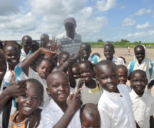 Children at Payuer Primary School in Renk, South Sudan, with the school's founder and head teacher, Ali Kenyi