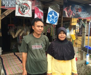 Nurita and her husband in front of their business