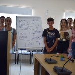 Members of the Cerrik Youth Council standing in front of their poster board.