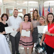 Young adults pose with USAID certificates