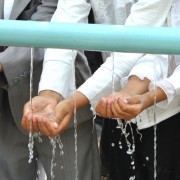 Children experience clean water running through their hands.