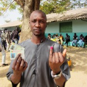 Senegalese holding his ID and voter's card after casting his vote in the 2012 presidential elections
