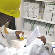 A warehouse staffer checks new stock of life-saving drugs for Guyana’s HIV/AIDS population.