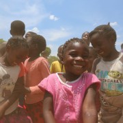 A young girl smiles and dances during a USAID/Zambia event in Eastern Province.