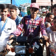 A nurse from the Maragusan Rural Health Unit, left, gets ready to visit patients in surrounding villages on a motorcycle taxi.