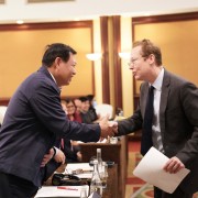 Vietnam's Vice Minister of Health Do Xuan Tuyen and U.S. Deputy Chief of Mission Christopher Klein shake hands during the event.
