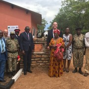 Zambia Minister of Tourism Charles Banda (center left) and U.S. Ambassador Daniel L. Foote (center right) join wildlife police, community leaders, and USAID program partners at unveiling of the refurbished Mukamba Gate Complex.