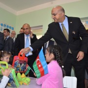 The Mission Director presents gifts to children during the tour of the renovated kindergarten.