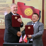 USAID Mission Director Gary Linden and Minister of Health Kosmosbek Cholponbaev exchange the signed statements.