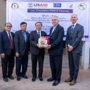 From left to right: Vice Minister of Health Dr. Bounfeng Phoummalaisith receives 50,000 USAID-donated malaria test kits from U.S. Ambassador to the Lao PDR Dr. Peter M. Haymond at a ceremony in Vientiane on November 13.