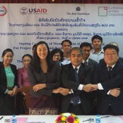 Signatories from The Asia Foundation, Government of Luang Prabang, and Luminous Action Organization shake hands after signing new cooperation agreement as U.S. Ambassador Rena Bitter (second row in center) and other officials witness the signing in Luang Prabang on January 31, 2018.