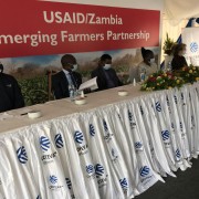 Representatives from USAID, Corteva, Global Communities, and John Deere sit at the high table during the launch of the Emerging Farmers Partnership Program in Lusaka on December 17