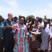 Minister of Fisheries Hon. Elizabeth Naa Afoley Quaye being assisted by Acting Economic Growth Director,  USAID/Ghana and Nii Ampofo Palm to symbolically open the oyster harvesting season.
