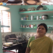Above: Many women in this Indian village use traditional cookstoves to cook rotis (Indian flat bread). Some who can afford to buy electric ones cannot use them because of daily power cuts. Below: Sumangala Patil with her solar-powered roti making machine. 