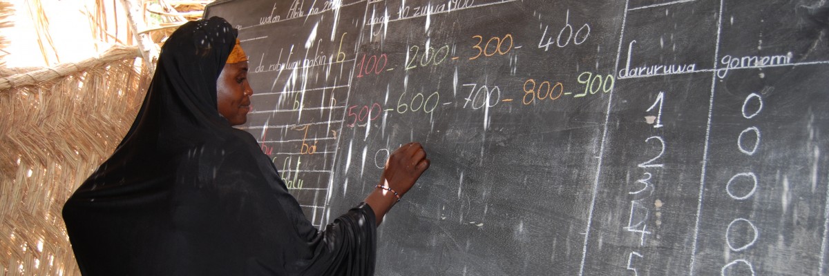 A Nigerien woman practices her reading and math skills
