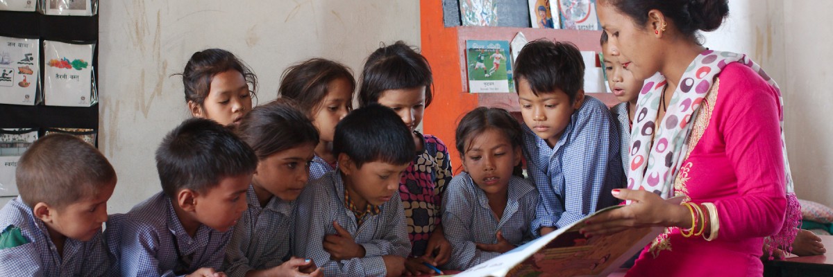 Rohini Shahi--a teacher at Kedareshwor Lower Secondary School in Kailali District--uses a storybook to teach Nepali language to students in second grade. Photo by Swadesh Maharjan for USAID 