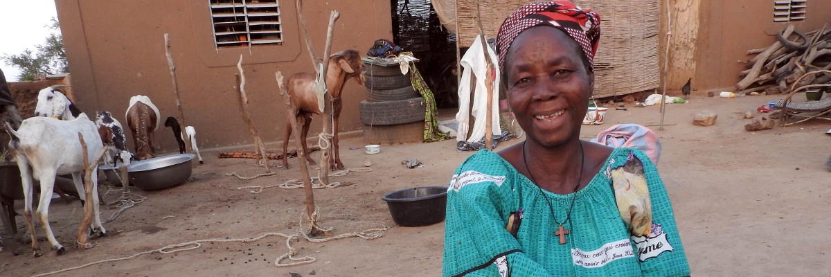 A Burkinabe woman showing off the goats she raised
