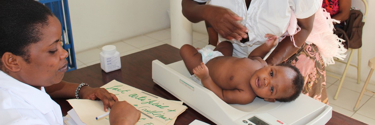 Baby receives checkup with help of community health worker.