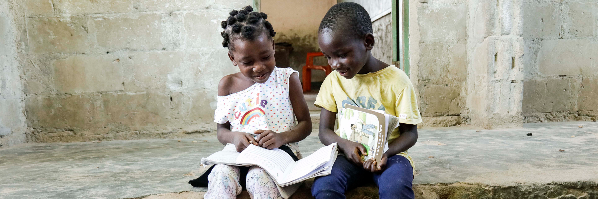 A little boy a girl reading a book