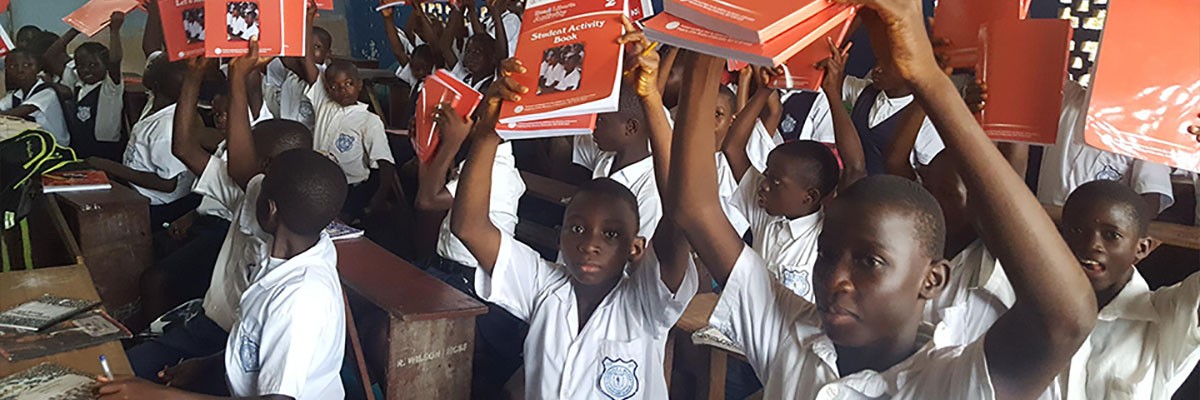 Liberians children with USAID-funded reading materials